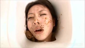 Mature Asian woman defecates on young girl's face